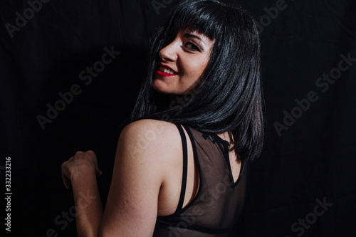 woman posing laughing on black background