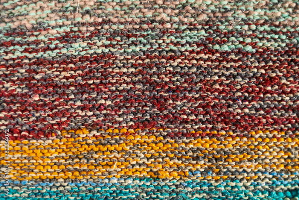 Multicolored knitted texture in macro using shawl technique Multicolored knitted texture in macro using shawl technique