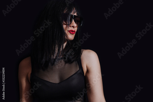 woman posing with glasses on black background