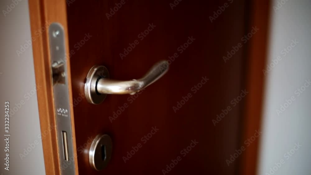 A man's hand cleans and sanitizes the door handle. Virus Warning A man's hand cleans and sanitizes the door handle. Virus Warning