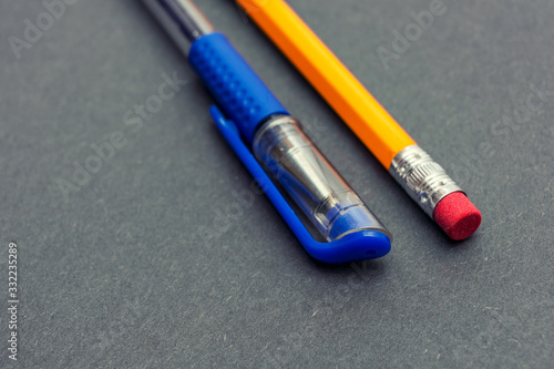 Blue pen on a dark gray surface. Office tool. Stationery. Back to school. Education. Place for text.