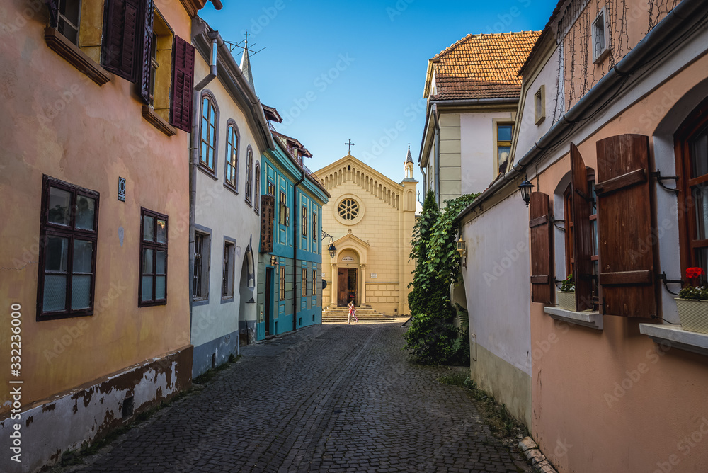Bastion Street in historic part of Sighisoara city, Romania- view with Cathedral of Saint Joseph