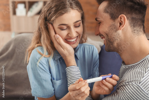 Happy young couple with pre...