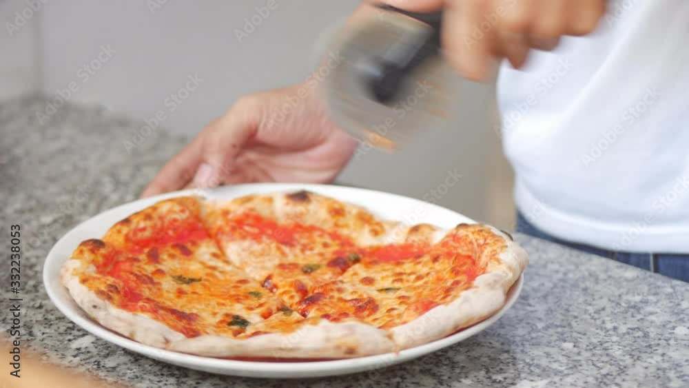 Freshly Baked Wood Fired Pizza Being Sliced and Served With Melty Cheesy. Footage Freshly Baked Wood Pizza of Slicing a Pepperoni Pizza into Multiple Slices With a pizza Cutter. Freshly Baked Wood Fired Pizza Being Sliced and Served With Melty Cheesy. Footage Freshly Baked Wood Pizza of Slicing a Pepperoni Pizza into Multiple Slices With a pizza Cutter.