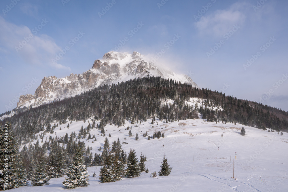 Mountain Velky Rozsutec in Male Fatra in winter and in high winds flying snow from the top, slovakia