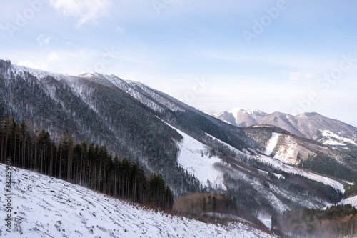 Ridge of Mala Fatra snowy with mountain Krivan in background and valley below, Slovakia Mala Fatra