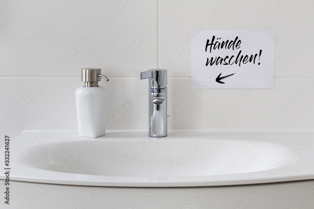 Fototapeta premium Sink with soap dispenser and note saying 