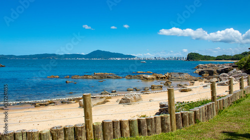 mar, rochas e céu azul na Praia tropical de Ilhota em Itapema, Santa Catarina photo