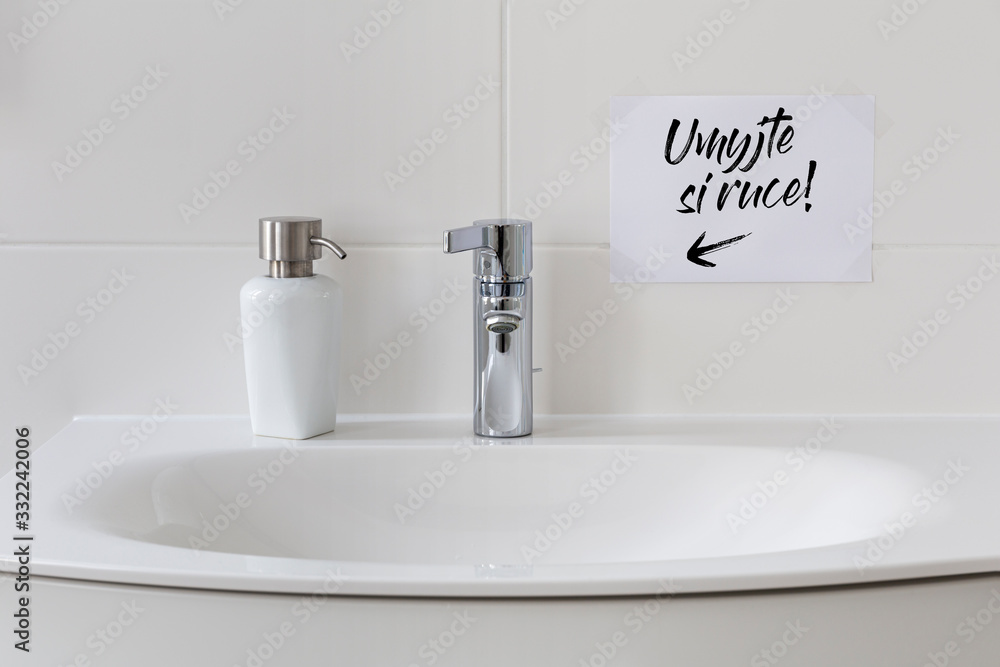 Fototapeta premium Sink with soap dispenser and note saying 