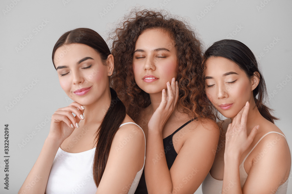 Beautiful young women with healthy skin on light background Beautiful young women with healthy skin on light background