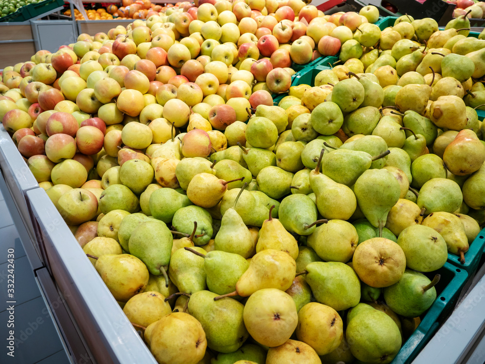Seasonal garden apples and pears. Sale of ripe apples in a vegetable store.