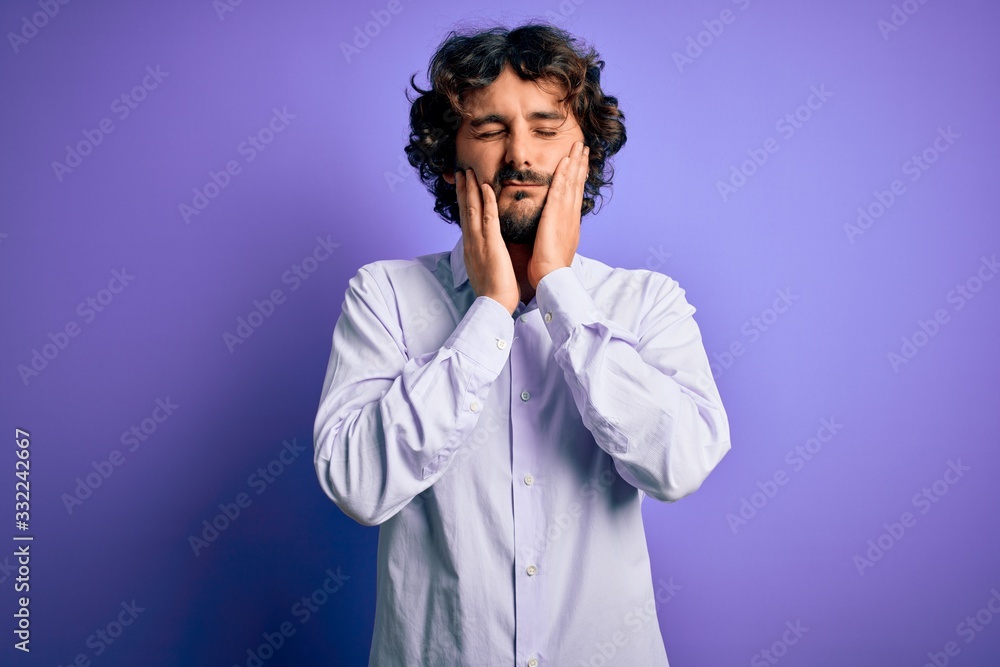 Young handsome business man with beard wearing shirt standing over purple background Tired hands covering face, depression and sadness, upset and irritated for problem Young handsome business man with beard wearing shirt standing over purple background Tired hands covering face, depression and sadness, upset and irritated for problem