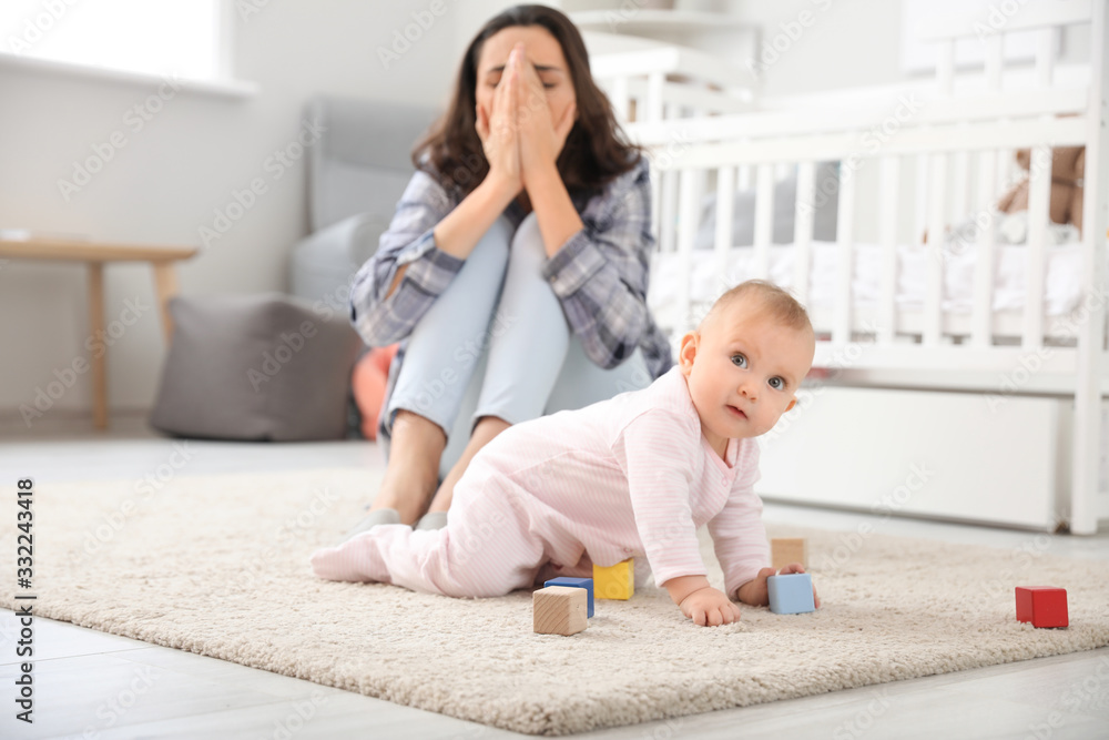 Young woman suffering from postnatal depression at home Young woman suffering from postnatal depression at home