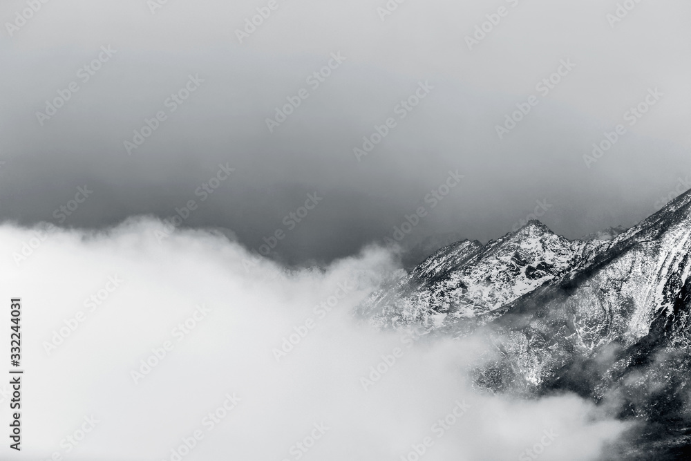 winter landscape of snow mountain peak in fog 
