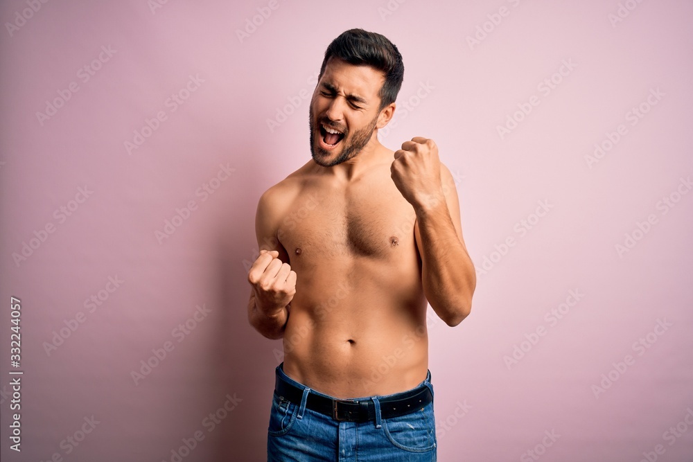 Young handsome strong man with beard shirtless standing over isolated pink background celebrating surprised and amazed for success with arms raised and eyes closed. Winner concept. Young handsome strong man with beard shirtless standing over isolated pink background celebrating surprised and amazed for success with arms raised and eyes closed. Winner concept.