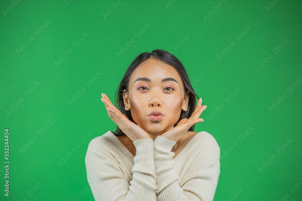 Beauty concept Asian girl holding handles face and making air kiss. Skin care, healthy lifestyle concept