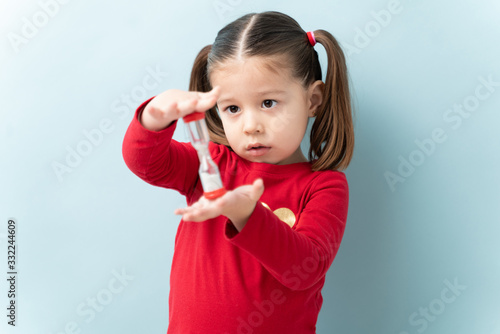 фотографія Portrait of a beautiful Caucasian girl holding a sand timer and practicing self