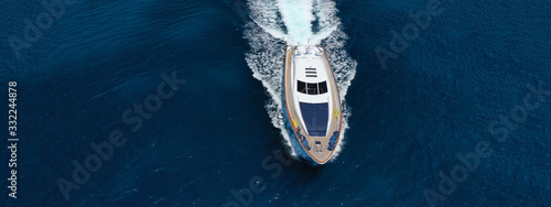 Aerial drone top down photo of luxury yacht with wooden deck anchored in open ocean sea © aerial-drone