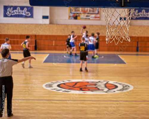 Match of young basketball players photo