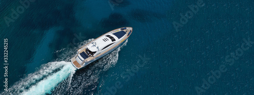 Aerial drone top down photo of luxury yacht with wooden deck anchored in open ocean sea © aerial-drone
