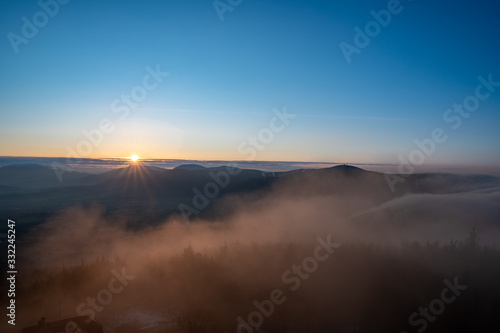 beautiful sunrise with mountains Velky Javornik with fog in valley, Czech Beskydy