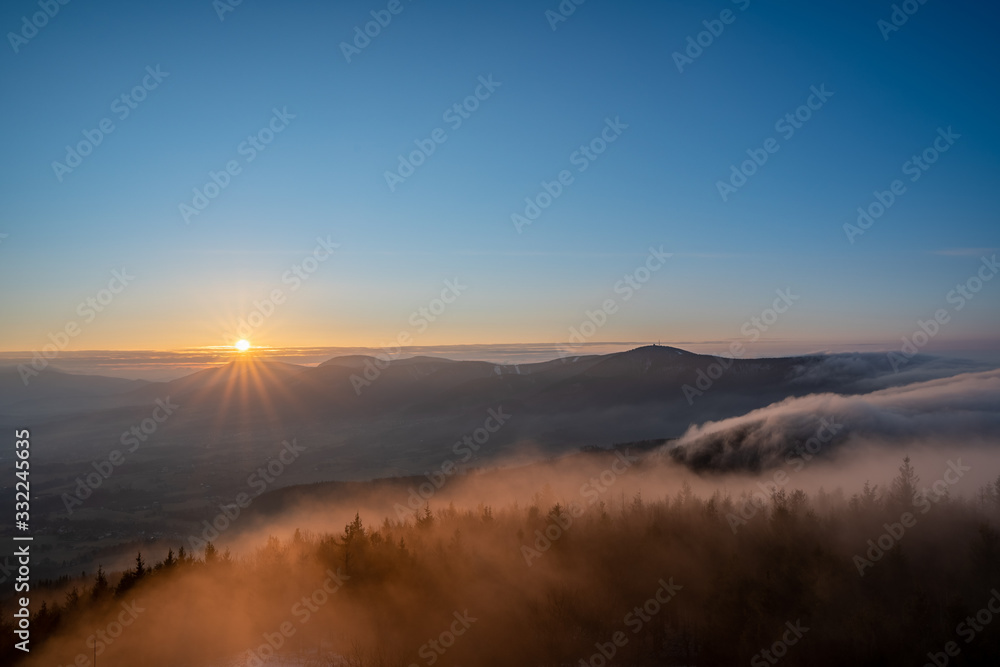 Sunrise in the mountains looking at Pustevny with a beauty mist in the valley, Czech Pustevny