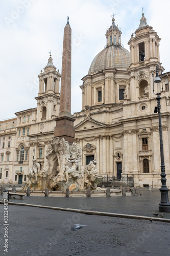 Famous Fountain of the Four Rivers with church of Sant'Agnese in Agone on empty Navona Square in Rome. Italy. Vertically. 