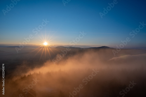 Sunrise in the mountains looking at Pustevny with a beauty mist in the valley  Czech Pustevny