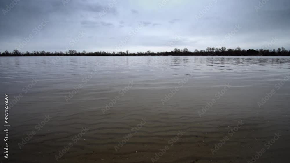 Landscape of a river or lake from the lower point with calm water. Landscape of a river or lake from the lower point with calm water.