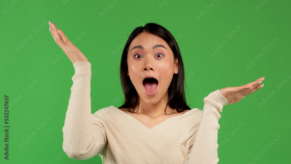 Wondering asian woman looking in camera excitedly and spreading her hands. Surprised happy young woman looking into camera with excitement. Chinese asian, white caucasian female mixed race model on Wondering asian woman looking in camera excitedly and spreading her hands. Surprised happy young woman looking into camera with excitement. Chinese asian, white caucasian female mixed race model on