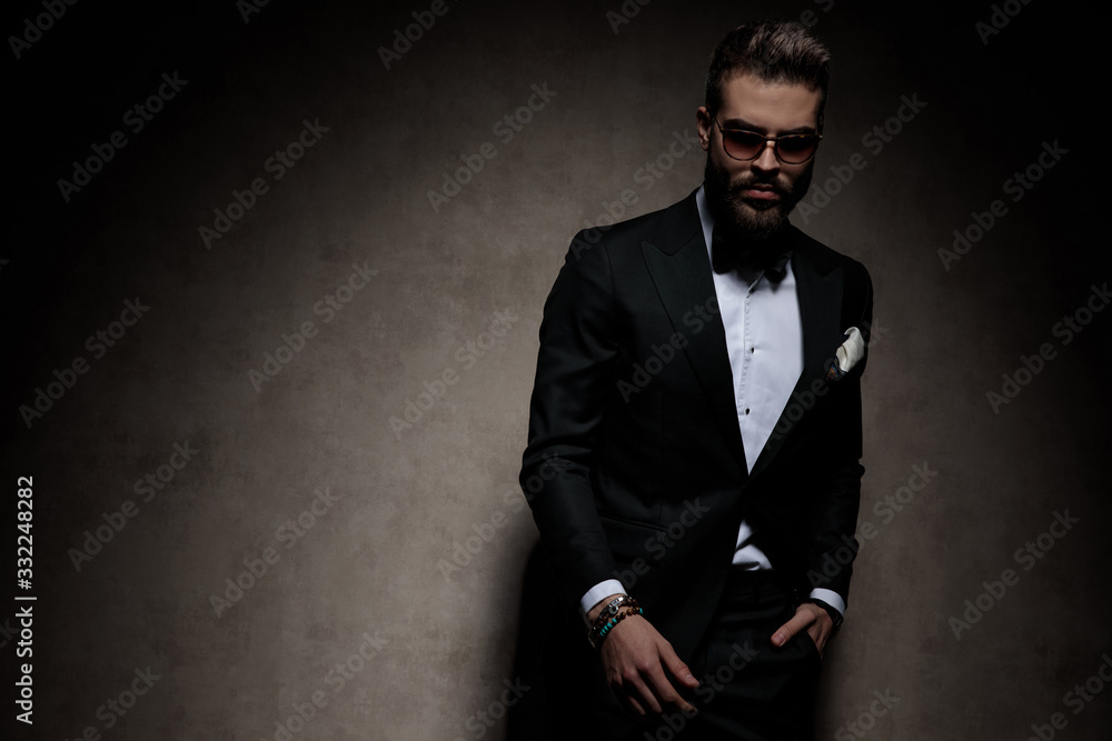 businessman standing with hand in pocket and posing cool businessman standing with hand in pocket and posing cool