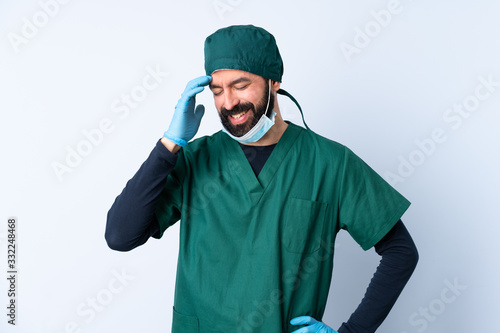 Surgeon man in green uniform over isolated background laughing