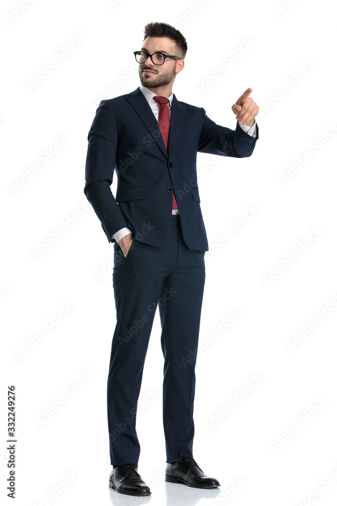businessman standing and pointing one way while looking the other businessman standing and pointing one way while looking the other
