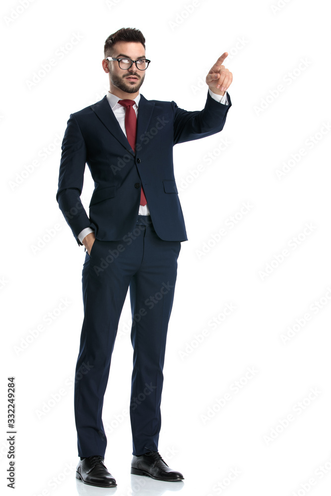 businessman standing and pointing forward serious