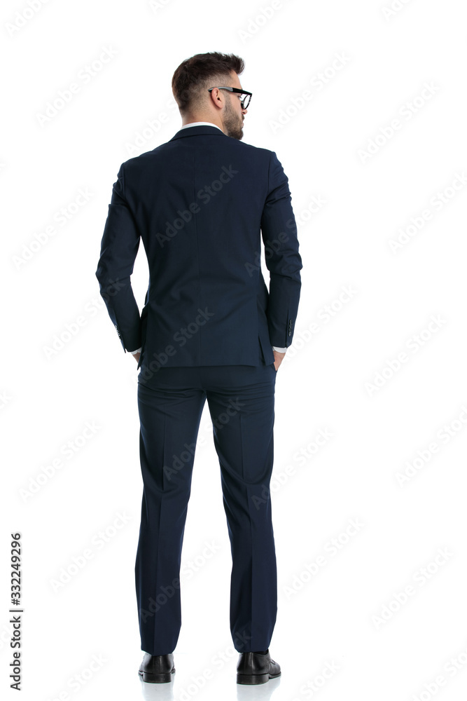 businessman standing with hands in pocket and looking aside businessman standing with hands in pocket and looking aside