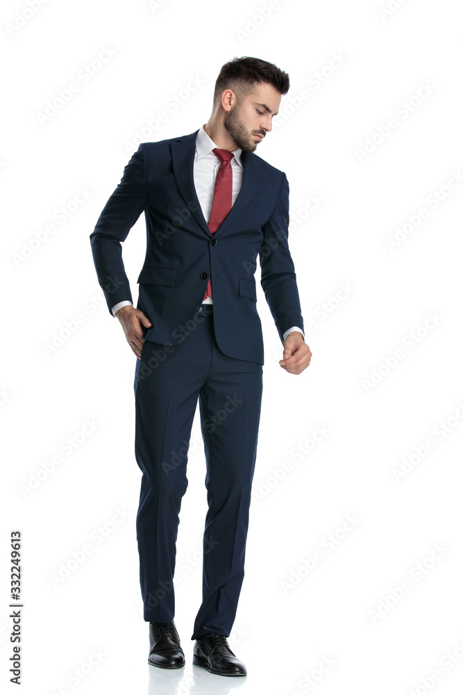businessman walking with hand in pocket and looking aside dramatic businessman walking with hand in pocket and looking aside dramatic