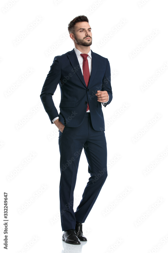 businessman walking with hand in pocket and posing tough businessman walking with hand in pocket and posing tough