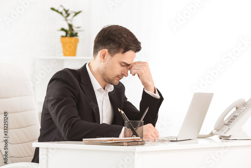 Tired businessman working i...