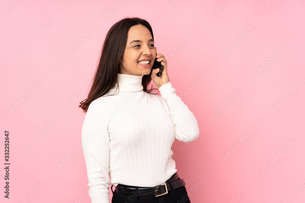Young woman with a mobile over isolated background Young woman with a mobile over isolated background