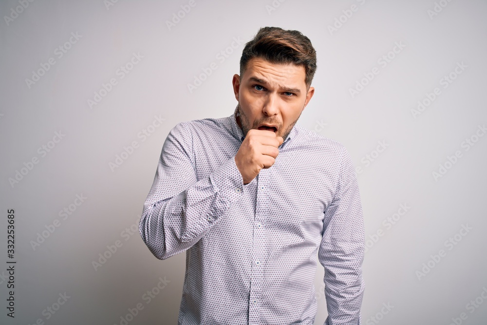 Young business man with blue eyes standing over isolated background feeling unwell and coughing as symptom for cold or bronchitis. Health care concept.