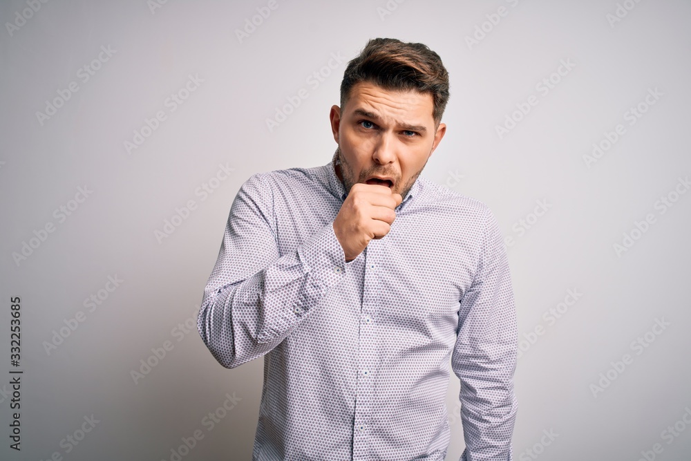 Young business man with blue eyes standing over isolated background feeling unwell and coughing as symptom for cold or bronchitis. Health care concept. Young business man with blue eyes standing over isolated background feeling unwell and coughing as symptom for cold or bronchitis. Health care concept.