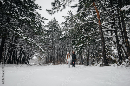 Wallpaper Mural A couple embraces in a snowy forest against a background of trees Torontodigital.ca