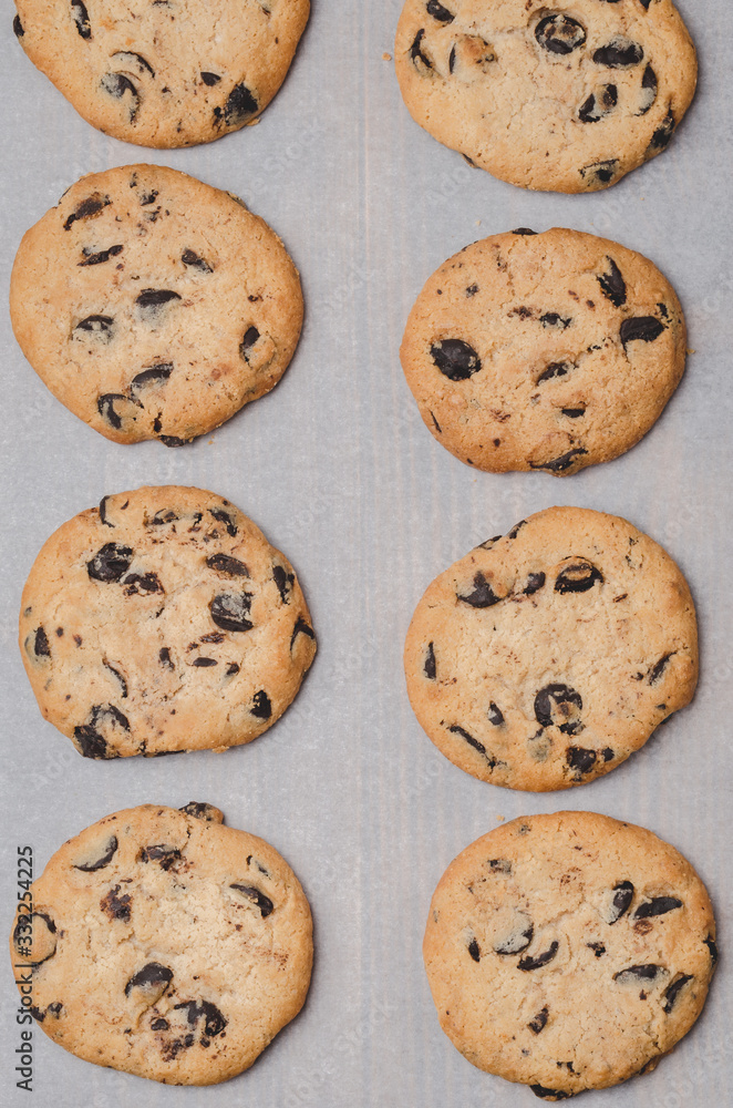 Cookies with chocolate filling on baking paper/Cookies with chocolate filling on baking paper. Fresh pastries. Top view.