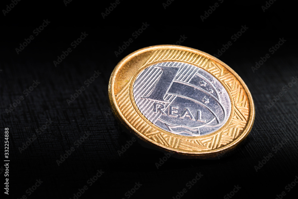 one real coins isolated on black background. Money from brazil. Brazil economy or financial crisis concept. one real coins isolated on black background. Money from brazil. Brazil economy or financial crisis concept.