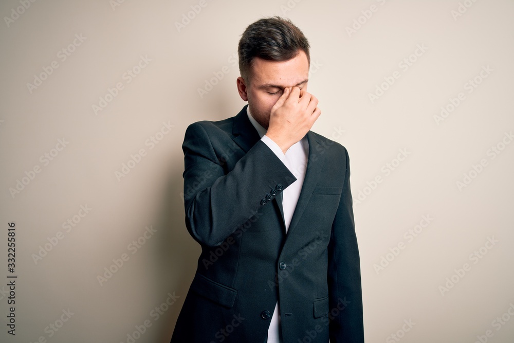 Young handsome business man wearing elegant suit and tie over isolated background tired rubbing nose and eyes feeling fatigue and headache. Stress and frustration concept. Young handsome business man wearing elegant suit and tie over isolated background tired rubbing nose and eyes feeling fatigue and headache. Stress and frustration concept.