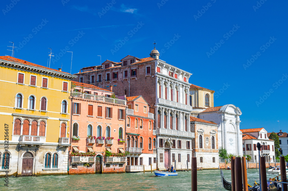 The Palazzo Flangini is a Baroque style palace building and Campo San Geremia Roman Catholic church on the Grand Canal waterway with boat in Cannaregio sestiere, Venice, Veneto Region, Northern Italy