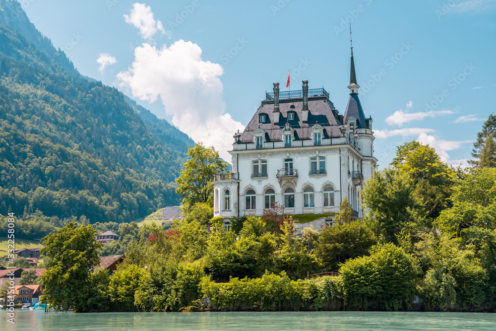 Schloss Seeburg. Seeburg castle was built on peninsula surrounded by the  teal coloredwaters of lake Brienz. Iseltwald, Switzerland. Stock Photo |  Adobe Stock