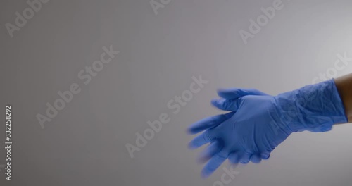 Hands slipping on gloves to not get infected photo