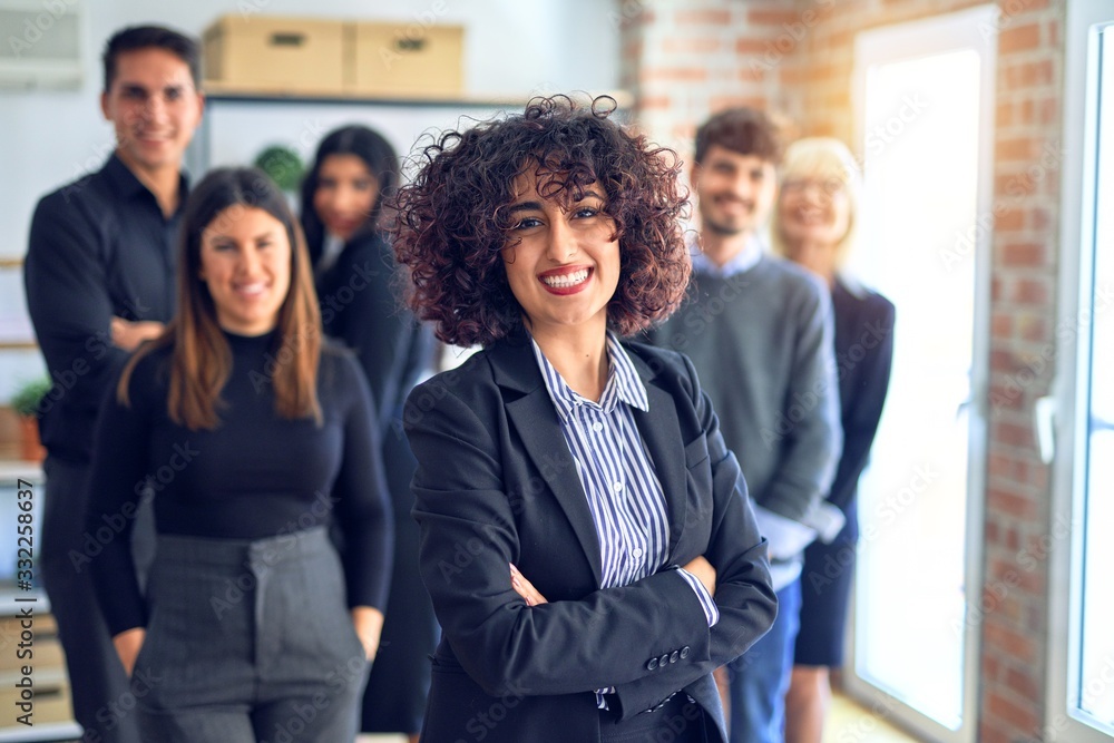 Obraz premium Group of business workers smiling happy and confident. Posing together with smile on face looking at the camera, young beautiful woman with crossed arms at the office