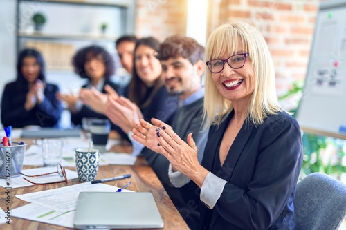 Wallpaper Mural Group of business workers smiling happy and confident. Working together with smile on face looking at the camera applauding at the office Torontodigital.ca
